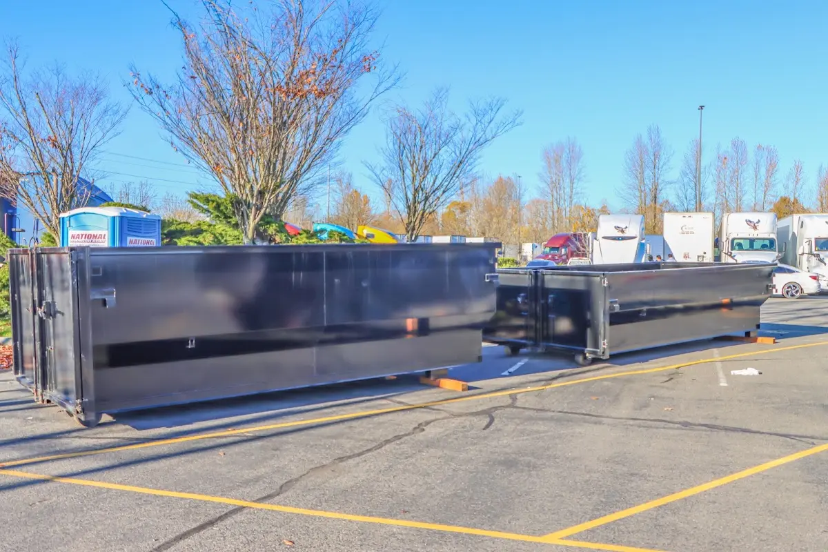 Professional dumpster rental service with roll-off container on residential driveway in Monaca
